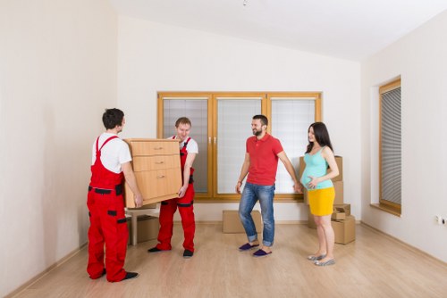 Professional movers handling household items in a Mayfair apartment